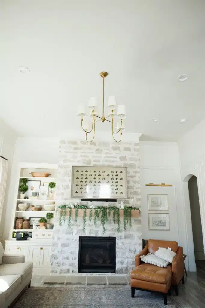 A cozy living room featuring a fireplace and a couch, showcasing elegant Crown Finish details.