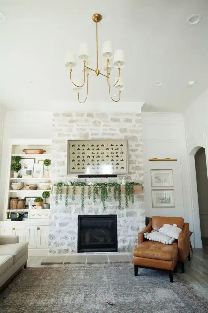 A cozy living room featuring a fireplace and a couch, showcasing elegant Crown Finish details.