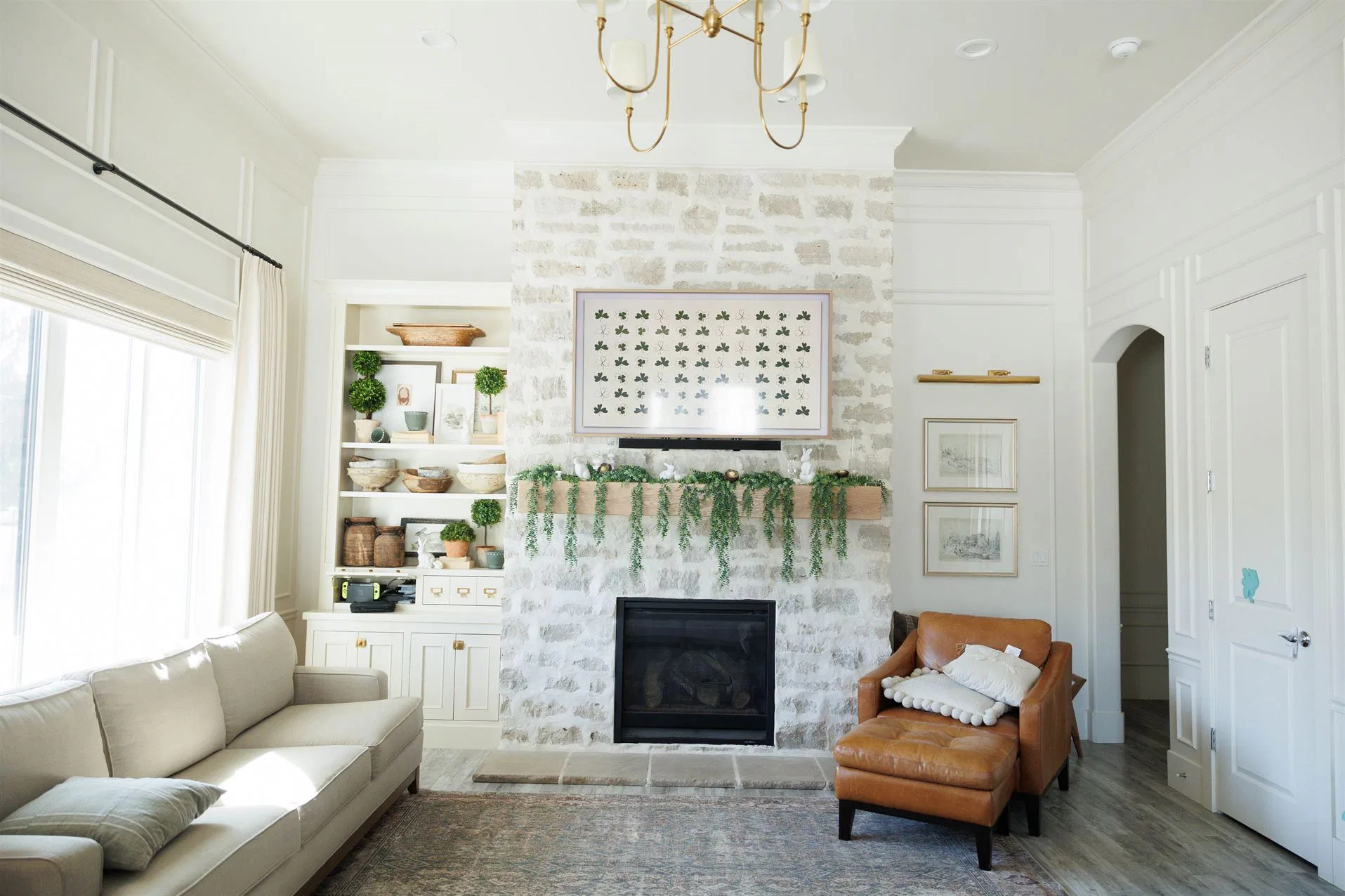 A cozy living room featuring a fireplace and a couch, showcasing elegant Crown Finish details.
